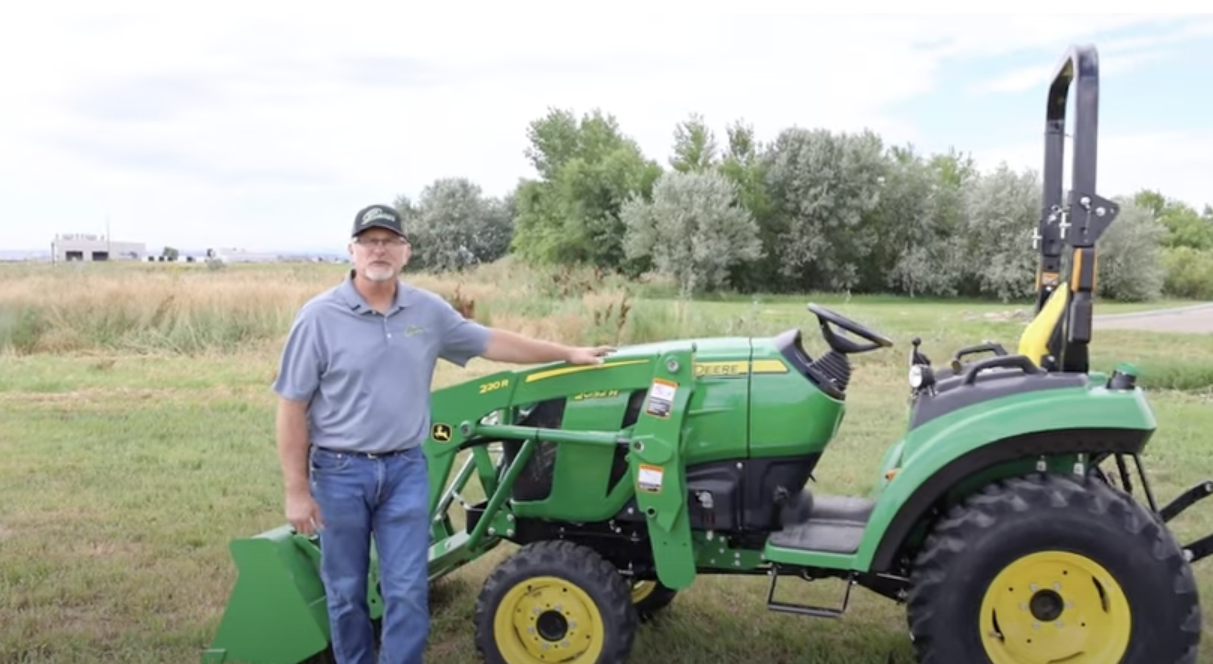 Neil Motley, standing next to the 2032R Tractor.